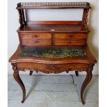 A 20th century mahogany Bonheur de Jour with 4 small drawers above a green leather writing area and
