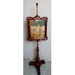 A fine Victorian carved mahogany pole screen with an inset tapestry panel, over a pedestal base,