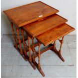 A 20th century nest of three yew wood graduated side tables,