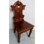 A small Victorian mahogany hall chair with a carved back splat over turned legs,