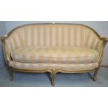 A 20th century gilt framed French style 2 seater settee upholstered in a Regency style cream/gold