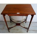 A small Edwardian rosewood side table with decoratively carved stretchers and terminating on