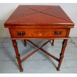 An Edwardian cross banded envelope card table with a drawer to one side over lower stretcher,