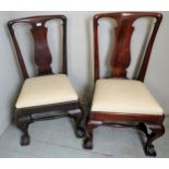 A pair of Georgian mahogany hall chairs with carved back splat's,