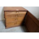 A small 19th century pale oak collectors cabinet with hinged panelled door revealing 4 internal