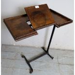 A late 19th/early 20th century bedside table with a folding bookrest over an iron moulded base with