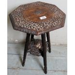 A decorative small Eastern two tiered side table with intricate carving,