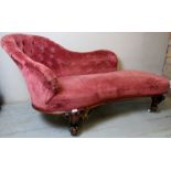 A Victorian walnut framed chaise longue upholstered in a deep buttoned pink velour material,