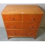 A mid 20th century satinwood chest of 2 short over 2 long drawers bearing a label James Colmer BATH,