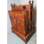 A mid-late 20th century Chinese dowry chest with carved panelled doors over a separate base with 2