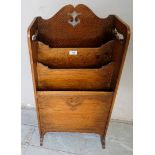 An early-mid 20th century pale oak Arts & Crafts magazine rack, in good condition,