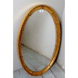 A 20th century oval gilt framed wall mirror,