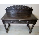 A Victorian carved oak hall table with a raised back over 2 frieze drawers,