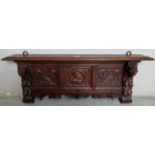 A decorative period style carved oak hanging coat rack,