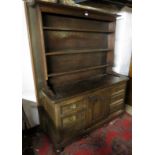 A 19th century oak high back dresser with an open plate rack to top over a central cup door to base