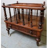 A pretty walnut Canterbury with turned upright spindles and magazine compartment over a single