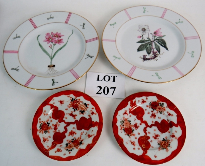A pair of hand painted plates with centr
