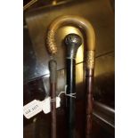 TWO WALKING STICKS AND A MILITARY SWAGGER STICK EACH HAVING METAL MOUNTED HANDLES