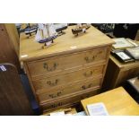 A 20TH CENTURY PINE FINISHED TALL SIX DRAWER CHEST WITH BRASS SWAN NECK HANDLES AND BRACKET STYLE