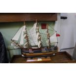 A MODEL SAILING SHIP OF THE HMS ENDEAVOUR ON WOODEN PLINTH STAND