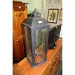 A MODERN MATT BLACK METAL FRAMED LANTERN WITH FOUR GLAZED PANEL SIDES