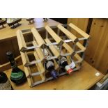 A SMALL WOOD AND GALVANISED METAL TABLE TOP SIXTEEN BOTTLE WINE RACK