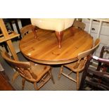 A MODERN PINE CIRCULAR DINING TABLE ON SINGLE CENTRAL COLUMN AND THREE DOWNSWEPT LEGS sold