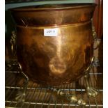 A COPPER COAL BIN , having brass lion mask ring handles on brass paw feet, together with TWO BRASS