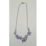 A TANZANITE SET SILVER NECKLACE of floral design