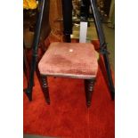 A VICTORIAN SQUARE PAD TOPPED STOOL on four ring turned legs