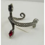 AN "ALCHEMY" PEWTER BRACELET of entwined serpent design, titled "Vipers Rite", No.A87, inset red