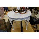 AN OFF WHITE PAINTED PIECRUST EDGE LOW CIRCULAR COFFEE TABLE ON FOUR CARVED CABRIEL LEGS