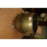A BRASS FINISHED LOG BIN with twin lion mask ring drop handles and three paw feet