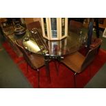 A MODERNIST DINING SUITE comprising extending circular glass top table supported on four chromed