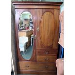 AN EDWARDIAN INLAID MAHOGANY WARDROBE having inlaid cornice over two oval panelled cupboard doors,