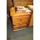 A MODERN PINE THREE DRAWER BEDSIDE UNIT ON PLINTH BASE WITH SQUASHED BUN FEET