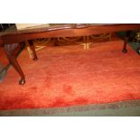 TWO IKEA WOVEN WOOL FLOOR RUGS finished in orange/red