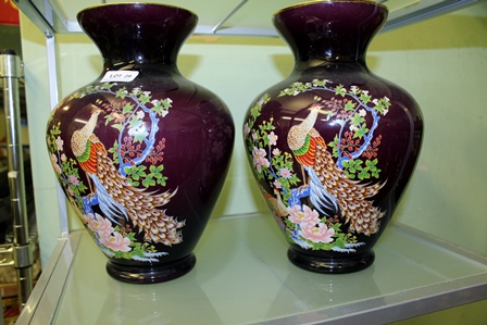 A PAIR OF PURPLE GROUND ORIENTAL DESIGN VASES, decorated with peacock amongst the boughs