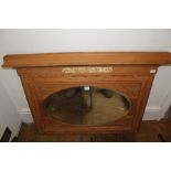 A 20TH CENTURY CARVED PINE FRAMED OVERMANTEL with insert oval bevel-plate mirror