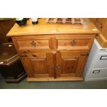 A PROBABLY IMPORTED SOFT WOOD SIDE UNIT WITH SHAPED UPSTAND BACK two inline drawers over two