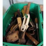A GREEN CRATE CONTAINING A SELECTION OF DOMESTIC TOOLS, various