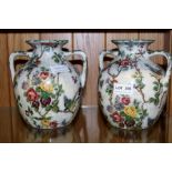 A PAIR OF POTTERY FLORAL CHINTZ DECORATED TWIN HANDLED VASES