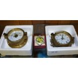 TWO BRASS SHIP'S PORTHOLE DESIGN WALL MOUNTABLE DEVICES, one being a quartz alarm clock, the other