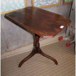 A 19TH CENTURY MAHOGANY WINE TABLE, having canted top on ring turned stem with three arched tripod