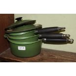 THREE CAST IRON GREEN FINISHED ENAMEL LE CRUSET PANS with lids, together with a Herb & Spice chest