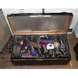 A BLACK FINISHED METAL TRUNK containing a selection of hand held Dyson vacuum cleaners (for spares &