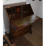 A WELL MADE REPRODUCTION MAHOGANY FINISH BUREAU of typical form and construction with skiver