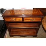 A REPRODUCTION MAHOGANY FINISHED LOW OPEN BOOKCASE with crossbanded top with two inline drawers,