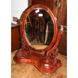 A 19TH CENTURY MAHOGANY OVAL ADJUSTABLE DRESSING TABLE MIRROR on plinth base with twin jewellery