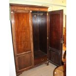 AN EARLY 20TH CENTURY SCOTTISH MAHOGANY WARDROBE having carved cornice over two flame panel cupboard